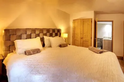 a bedroom with a large bed with white pillows at MGM Charles Delys - 3 Rooms - Les Houches in Les Houches