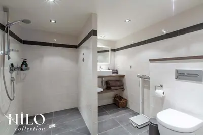 a bathroom with a shower and a toilet and a sink at Chalet La Moraine Chamonix Mont Blanc by HILO Collection - 8 people - Jacuzzi and PS5 in Chamonix-Mont-Blanc