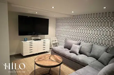 a living room with a couch and a flat screen tv at Chalet La Moraine Chamonix Mont Blanc by HILO Collection - 8 people - Jacuzzi and PS5 in Chamonix-Mont-Blanc