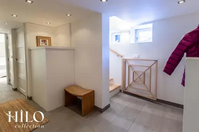 a room with a closet with a door and a bench at Chalet La Moraine Chamonix Mont Blanc by HILO Collection - 8 people - Jacuzzi and PS5 in Chamonix-Mont-Blanc