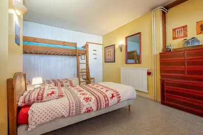 a bedroom with a bed and a dresser at In the center of Chamonix with views of Mont Blanc in Chamonix-Mont-Blanc