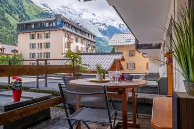 a living room with a table and a couch at In the center of Chamonix with views of Mont Blanc in Chamonix-Mont-Blanc