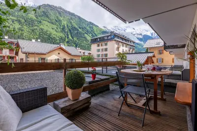a living room with a table and a couch at In the center of Chamonix with views of Mont Blanc in Chamonix-Mont-Blanc