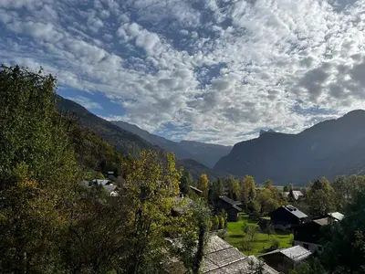 a village in the mountains under a cloudy sky at Chalet La Ponote in Samoëns