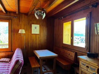 a room with a table in a wooden cabin at Chalet La Ponote in Samoëns
