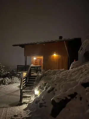 a building with snow on the ground in front of it at Chalet La Ponote in Samoëns