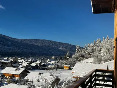 a view of a snow covered village with houses at Chalet La Ponote in Samoëns