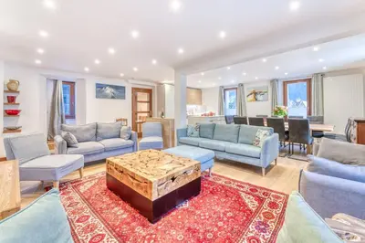 a living room with a couch and a coffee table at Chalet L'Argoat - Warm and cosy 6 bedroom chalet in Chamonix-Mont-Blanc