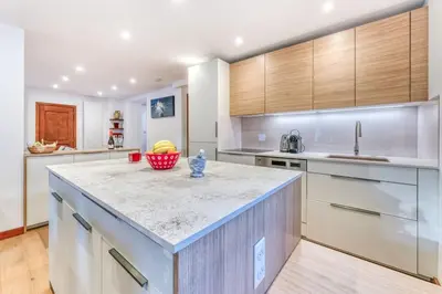 a kitchen with a counter with a bowl of fruit on it at Chalet L'Argoat - Warm and cosy 6 bedroom chalet in Chamonix-Mont-Blanc
