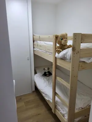 a teddy bear sitting on top of a bunk bed at Appartement proche télécabine in Saint-Gervais-les-Bains
