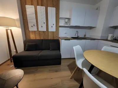 a living room with a couch and a table at Appartement proche télécabine in Saint-Gervais-les-Bains