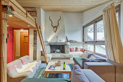 a living room with a couch and a fireplace at Appartement Le Grenier - Happy Rentals in Chamonix-Mont-Blanc