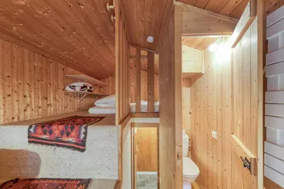 a log cabin with a bed and a toilet in it at Appartement Le Grenier - Happy Rentals in Chamonix-Mont-Blanc