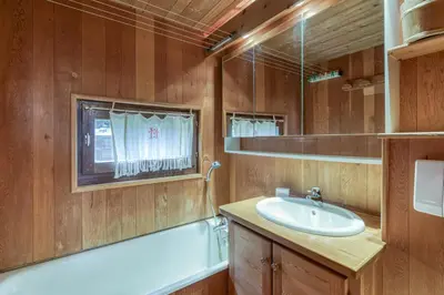 a bathroom with a sink and a tub and a window at Appartement Le Grenier - Happy Rentals in Chamonix-Mont-Blanc