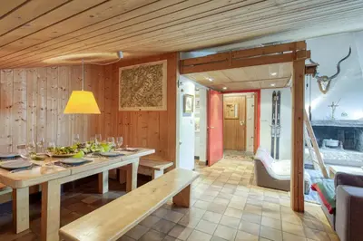 a dining room with a table and a couch at Appartement Le Grenier - Happy Rentals in Chamonix-Mont-Blanc