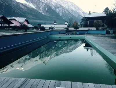 a swimming pool with a reflection of a mountain at Apartment in Chamonix in Chamonix-Mont-Blanc