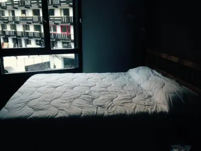 an unmade bed in a bedroom with a window at Apartment in Chamonix in Chamonix-Mont-Blanc