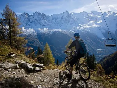 a golf course in the mountains with mountains at Hôtel Les Chalets de Philippe avec Jacuzzis Privatifs in Chamonix-Mont-Blanc