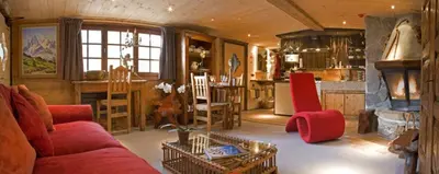 a room with a large window with a view of the mountains at Hôtel Les Chalets de Philippe avec Jacuzzis Privatifs in Chamonix-Mont-Blanc