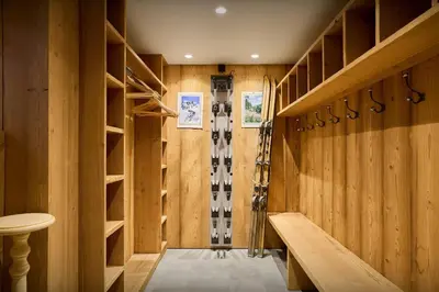 a dressing room with wood paneling and a skis on the wall at Chalet Anselme - OVO Network in Cordon