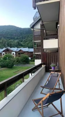 a chair sitting on the balcony of a house at Appartement 4 personnes centre village in Samoëns