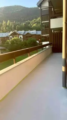 a balcony of a building with a view of a town at Appartement 4 personnes centre village in Samoëns