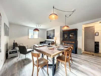 a dining room and living room with a table and chairs at Chamonix : Appartement 63 m², 6 pers, Confort & Wifi - FR-1-507-78 in Chamonix-Mont-Blanc