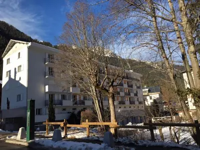 a white building with a tree in front of it at Chamonix : Appartement 63 m², 6 pers, Confort & Wifi - FR-1-507-78 in Chamonix-Mont-Blanc