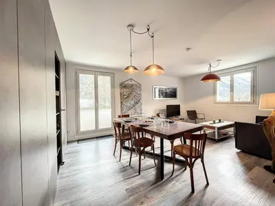 a kitchen and dining room with a table and chairs at Chamonix : Appartement 63 m², 6 pers, Confort & Wifi - FR-1-507-78 in Chamonix-Mont-Blanc