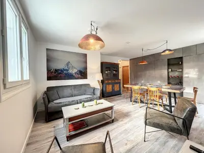 a living room with a couch and a table at Chamonix : Appartement 63 m², 6 pers, Confort & Wifi - FR-1-507-78 in Chamonix-Mont-Blanc