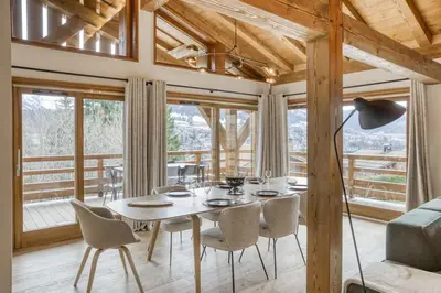 a dining room with a table and chairs at Chalet de Denis luxe alpin et emplacement ideal à Megeve in Megève