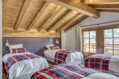 a bedroom with two beds and a wooden ceiling at Chalet de Denis luxe alpin et emplacement ideal à Megeve in Megève