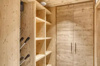 a wooden walk in closet with wooden walls and shelves at Chalet de Denis luxe alpin et emplacement ideal à Megeve in Megève