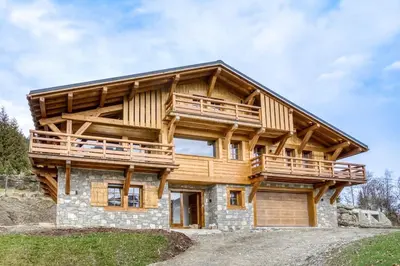 a log home with a wrap around deck at Chalet de Denis luxe alpin et emplacement ideal à Megeve in Megève
