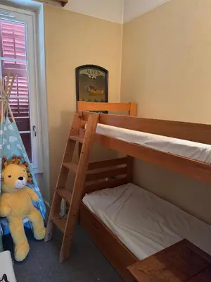 a bedroom with two bunk beds and a teddy bear at Appartement vue Mont Blanc in Combloux