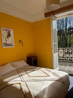 a bedroom with a bed and a large window at Appartement vue Mont Blanc in Combloux