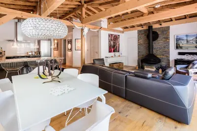 a living room with a couch and a table at Le Bartavel Apartment - Chamonix All Year in Chamonix-Mont-Blanc