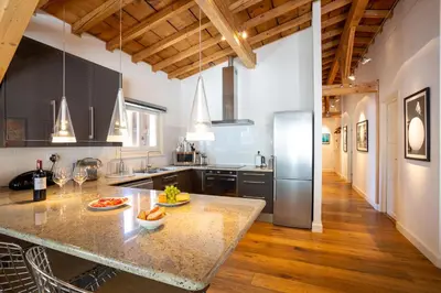 a kitchen with a large island in the middle of a room at Le Bartavel Apartment - Chamonix All Year in Chamonix-Mont-Blanc