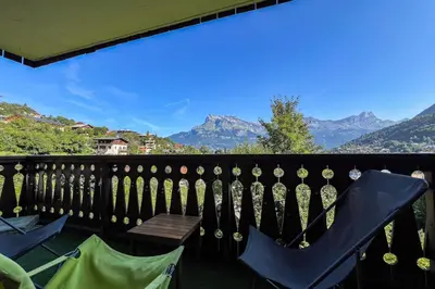 a balcony with chairs and a view of mountains at Charming T2 in Saint-Gervais-les-Bains in Saint-Gervais-les-Bains