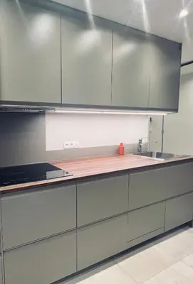 a kitchen with gray cabinets and a sink at Les hirondelles in Passy