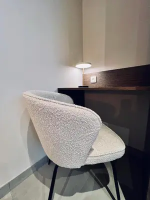 a white chair sitting next to a desk at Les hirondelles in Passy