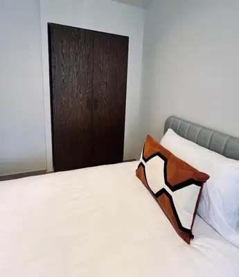 a bedroom with a white bed with a wooden door at Les hirondelles in Passy