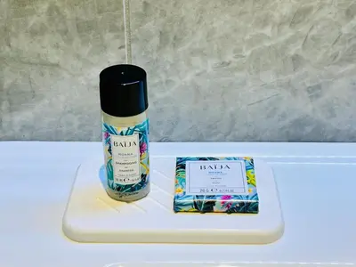 a bottle of raisin soap and a box on a table at Les hirondelles in Passy