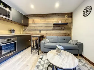 a living room with a couch and a table at Centre village station ski in Saint-Gervais-les-Bains