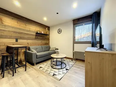 a living room with a couch and a table at Centre village station ski in Saint-Gervais-les-Bains