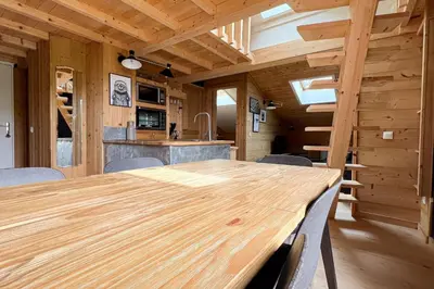 a dining room with a wooden table and chairs at T2 with pool in Saint-Gervais-les-Bains in Saint-Gervais-les-Bains