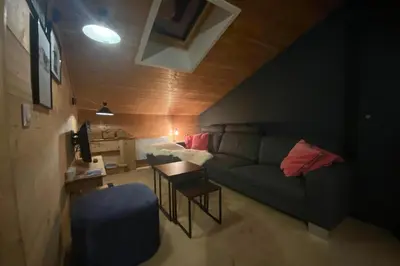 a living room with a couch and a table at T2 with pool in Saint-Gervais-les-Bains in Saint-Gervais-les-Bains