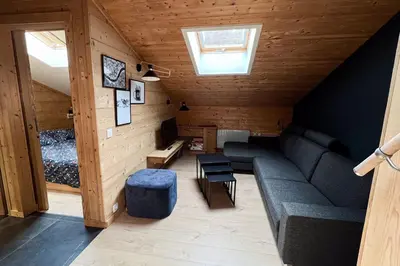 a living room with a couch in the attic at T2 with pool in Saint-Gervais-les-Bains in Saint-Gervais-les-Bains