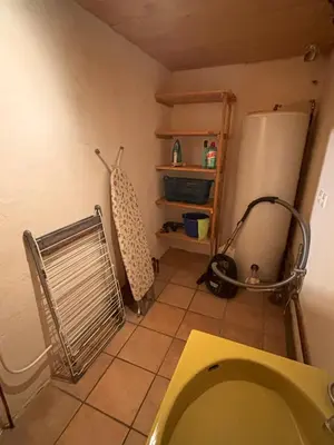 a bathroom with a sink and a refrigerator at Appartement Chamonix in Chamonix-Mont-Blanc