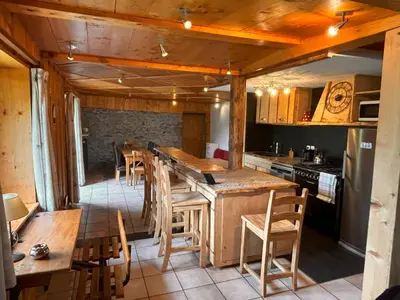 a kitchen with a table and some chairs in it at Appartement Chamonix in Chamonix-Mont-Blanc